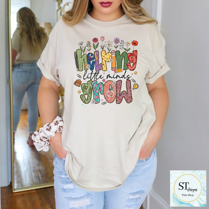 Helping Little Minds Grow Teacher T-Shirt | Cute Floral Teacher Graphic Tee | Preschool & Elementary Teacher Shirt | Unisex S-5XL