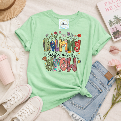 Helping Little Minds Grow Teacher T-Shirt | Cute Floral Teacher Graphic Tee | Preschool & Elementary Teacher Shirt | Unisex S-5XL
